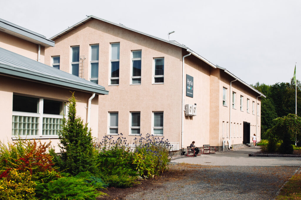 An old beige concrete building in the Hyria's campus