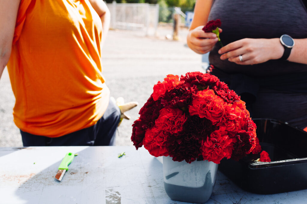 Students are tying a bouquet of red flowers