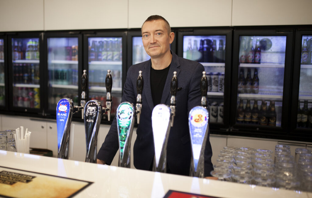 Timo Mikkola stands behind the bar counter