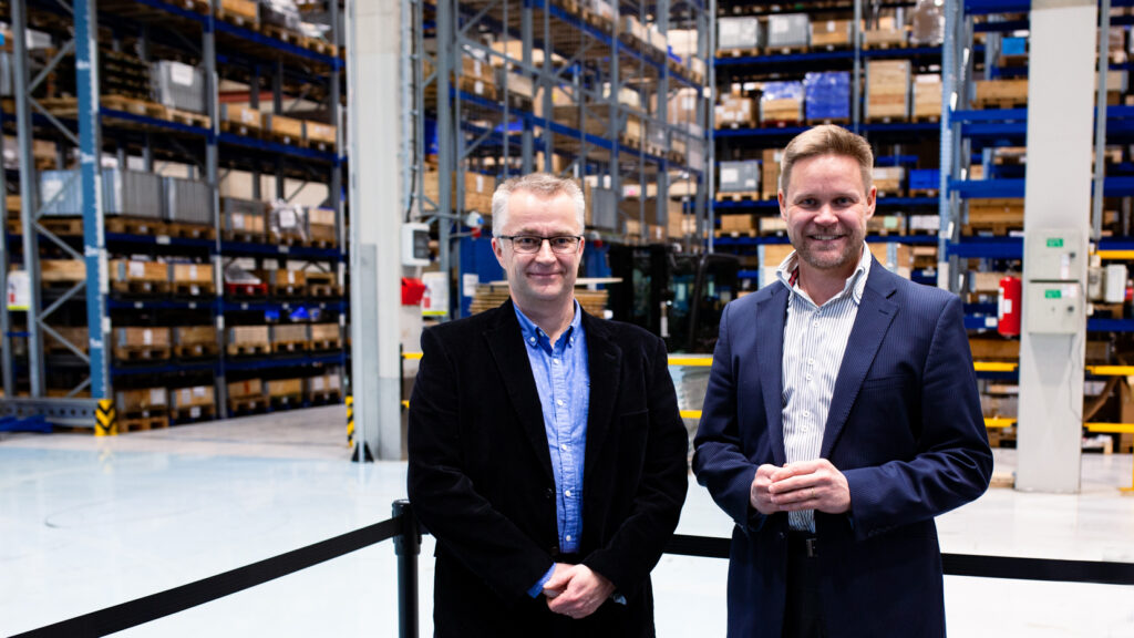 Juha Nyman and Oskari Lindstedt smiling on Mitsubishi logistic center