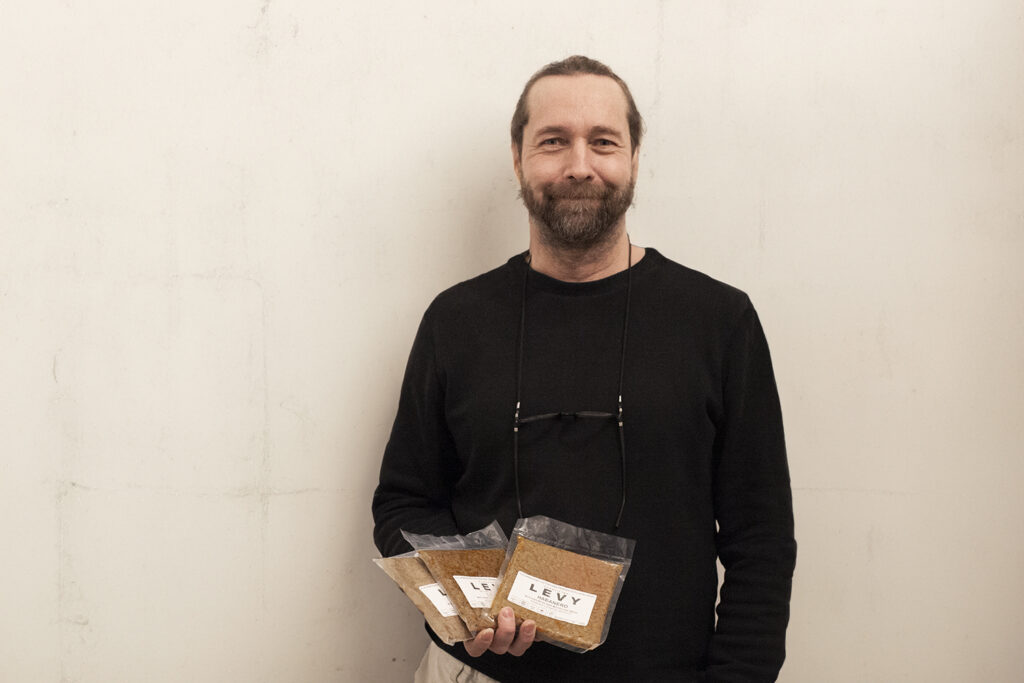 Jarmo Lipasti, founder and owner of Gary Renegadethe is holding packages of Pornaisten Levy, a mass made from fermented faba beans that you can shape as you wish.