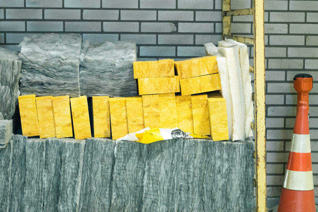 Saint-Gobain manufacturing energy-efficient thermal insulation from recycled glass, different versions on display: yellow and grey wool